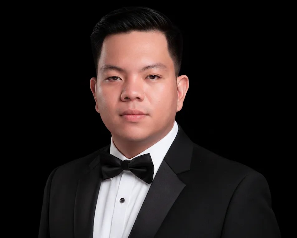 Portrait of Dann Reister Abong in a black tuxedo